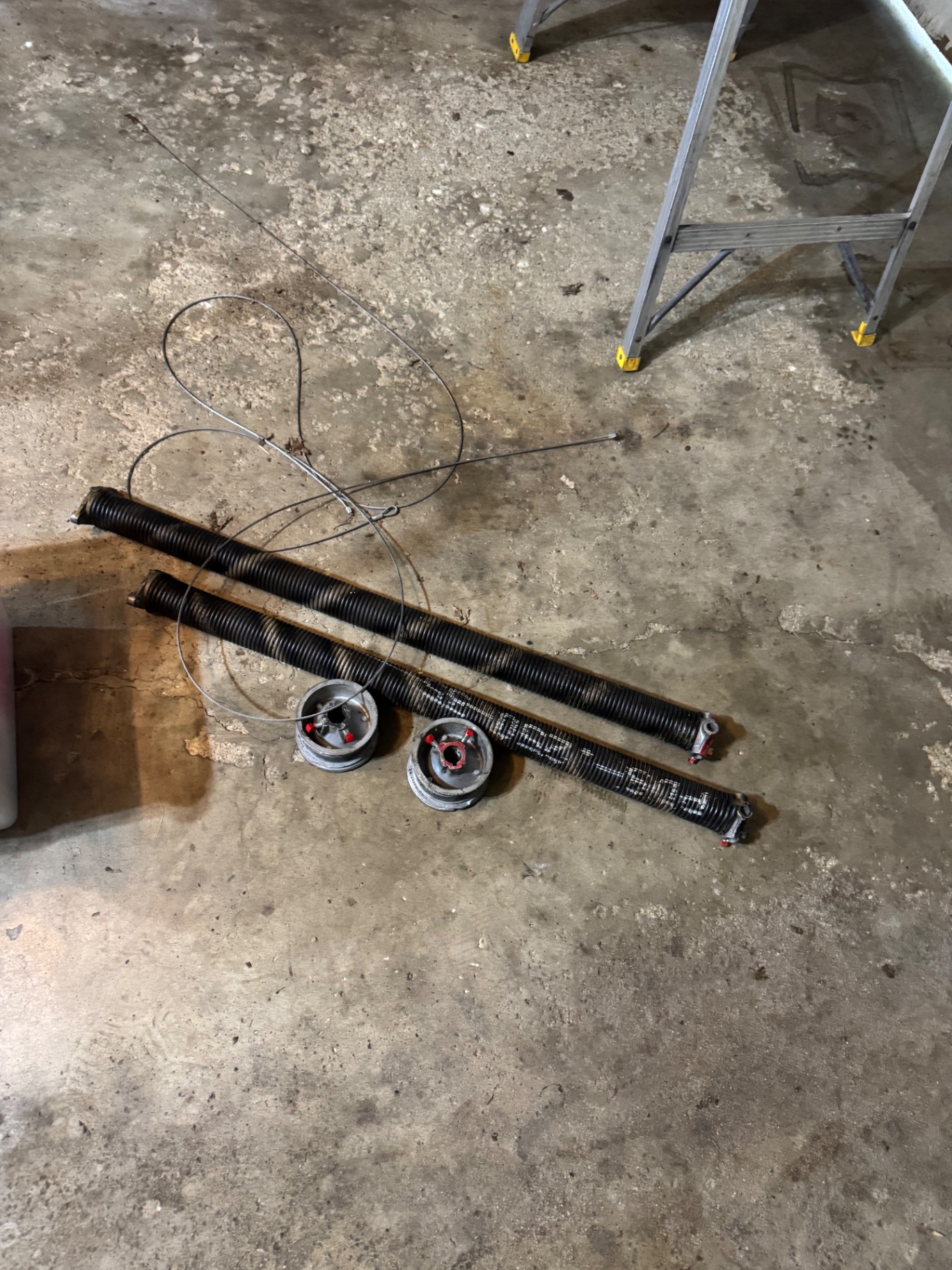 Before — Broken garage door springs replaced with new torsion springs