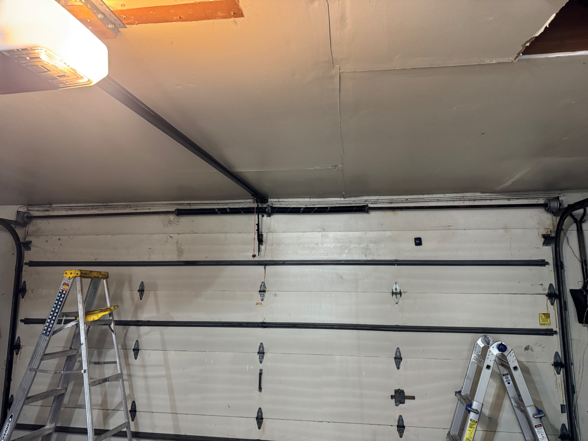 After — Snapped garage door spring replaced and door re-balanced